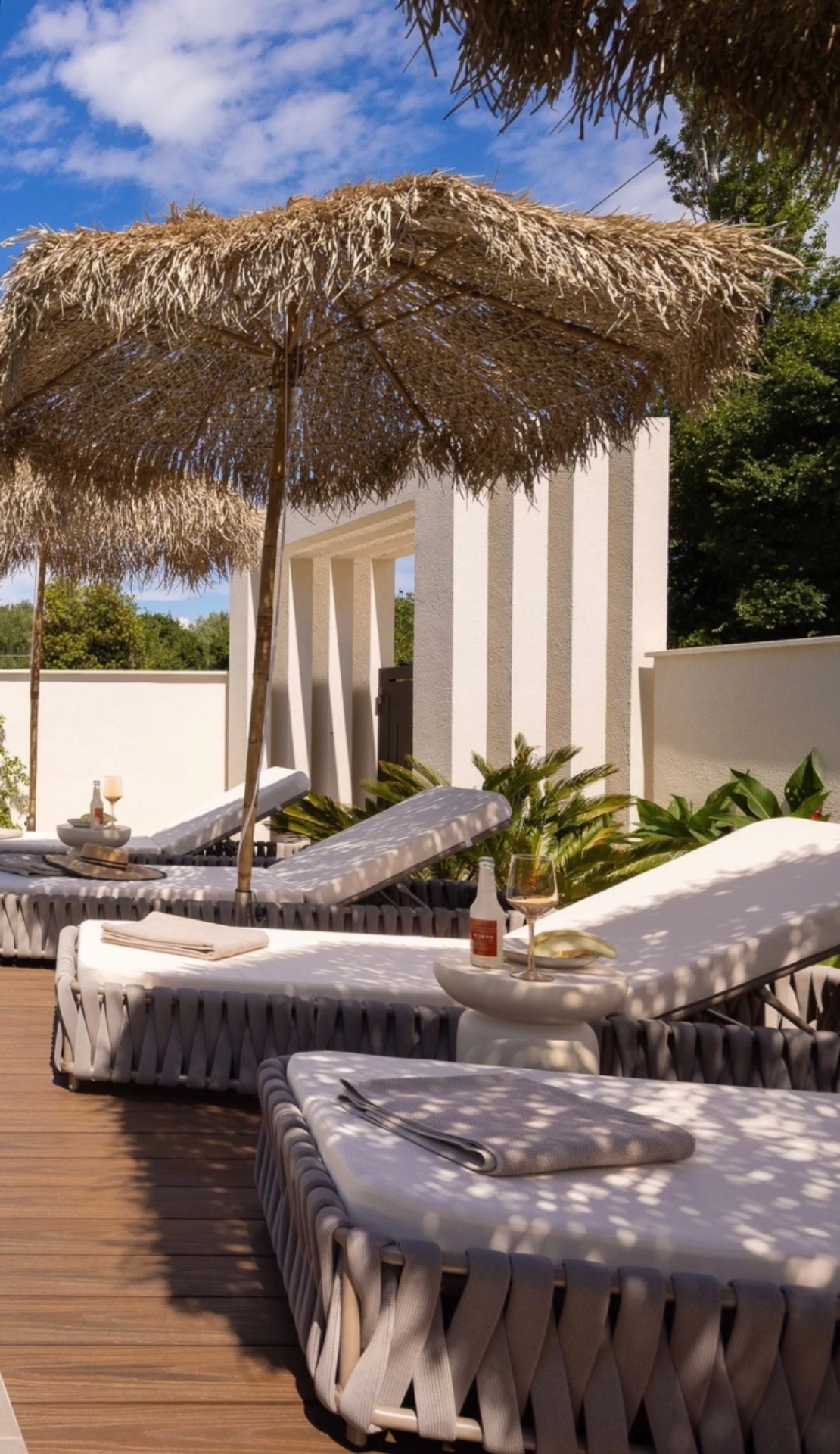 Sunbeds under straw palapas at Casa al Este